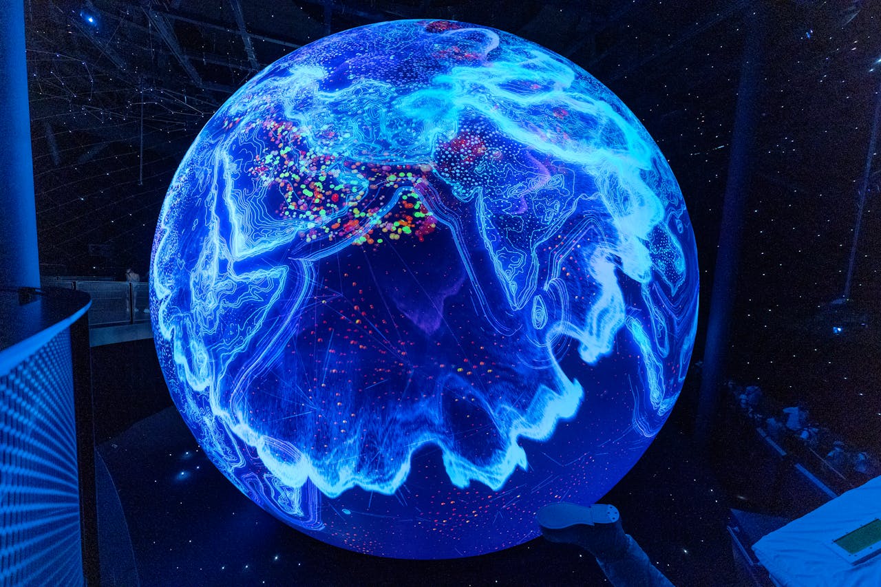 About A vibrant illuminated globe display showcasing technological advancements at a science museum.